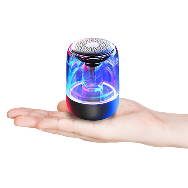 Portable Bluetooth speaker with powerful bass and variable color LED light, compact wireless design for outdoor use.