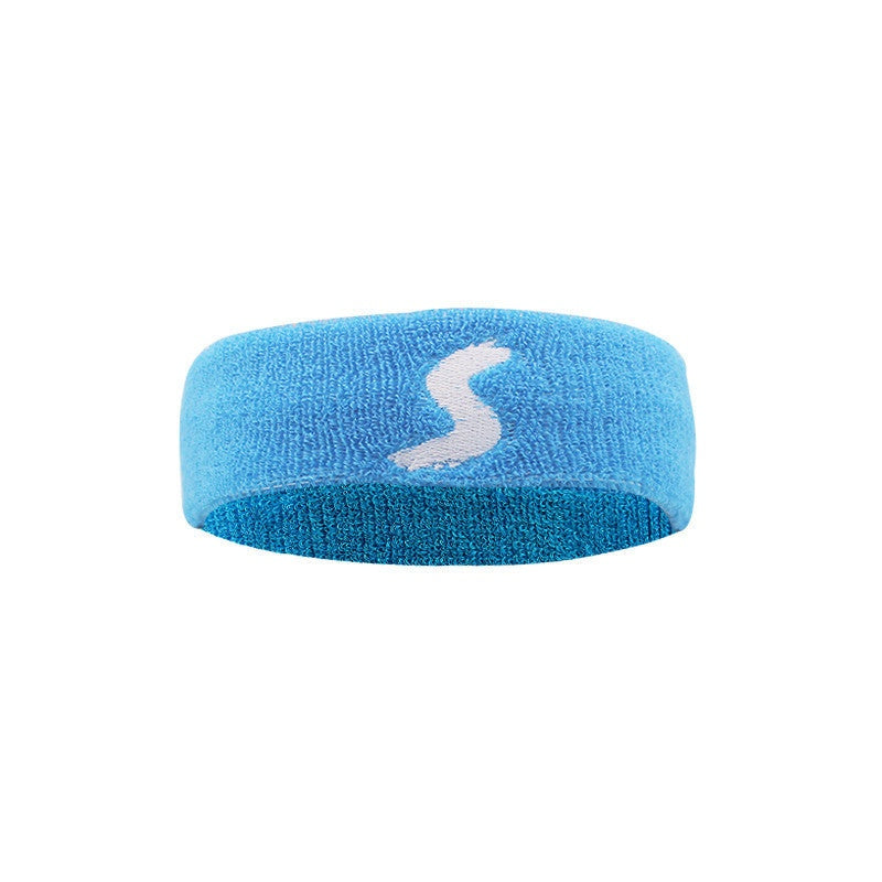 Fitness headband in white, yellow, blue, and black cotton fabric shown on a woman wearing black fitness headband while preparing for workout