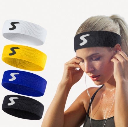 Fitness headband in white, yellow, blue, and black cotton fabric shown on a woman wearing black fitness headband while preparing for workout